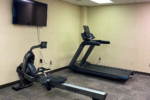 Fitness Center with flat screen tv in front of rowing machine and treadmill